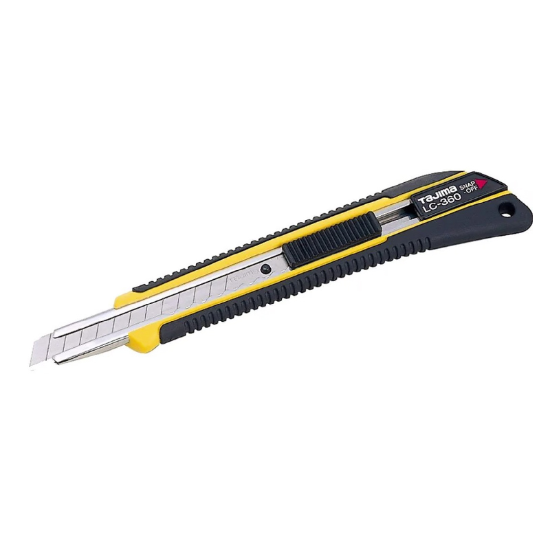 CUTTER BLOQ-AUTOM GOMA CON 1 HOJA 9MM TAJIMA — Tajima